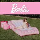 Kids air mattress in pink with Barbie branding, featuring a girl sitting on it, surrounded by outdoor grass.