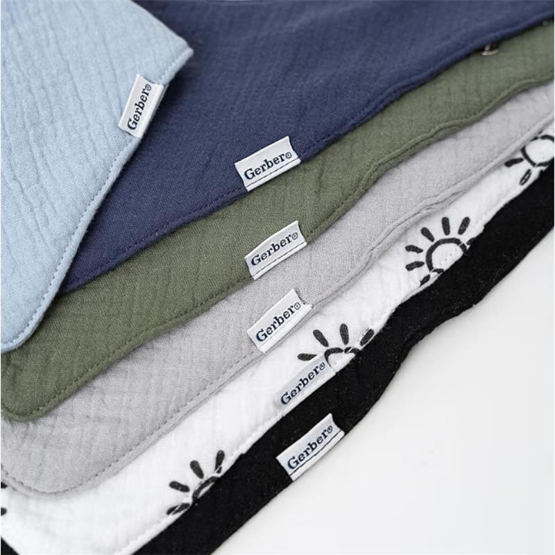 Multi-colored muslin bandana bibs for baby boys by Gerber, featuring blue, navy, green, gray, white with sun print, and black.