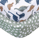 Knit crib sheets featuring dinosaur prints in various colors and a solid green sheet with white dots pattern.