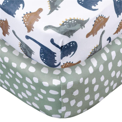 Knit crib sheets featuring dinosaur prints in various colors and a solid green sheet with white dots pattern.