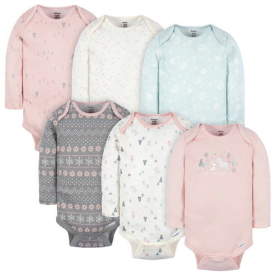 Six long sleeve onesies for baby girls, featuring pastel colors and playful patterns including flowers and winter motifs.