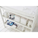 Gerber 4-pack short sleeve bodysuits in white displayed on a white shelf, alongside folded diapers and a soft toy.