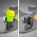 Backless booster car seat with cup holders, featuring a bright green striped drink container in one holder and an empty holder in the other.