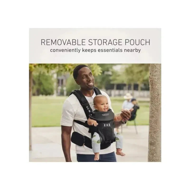 Graco Premier Cradle Me Air 4-in-1 Baby Carrier in Onyx Black, featuring a removable storage pouch, used by a smiling man with a baby.