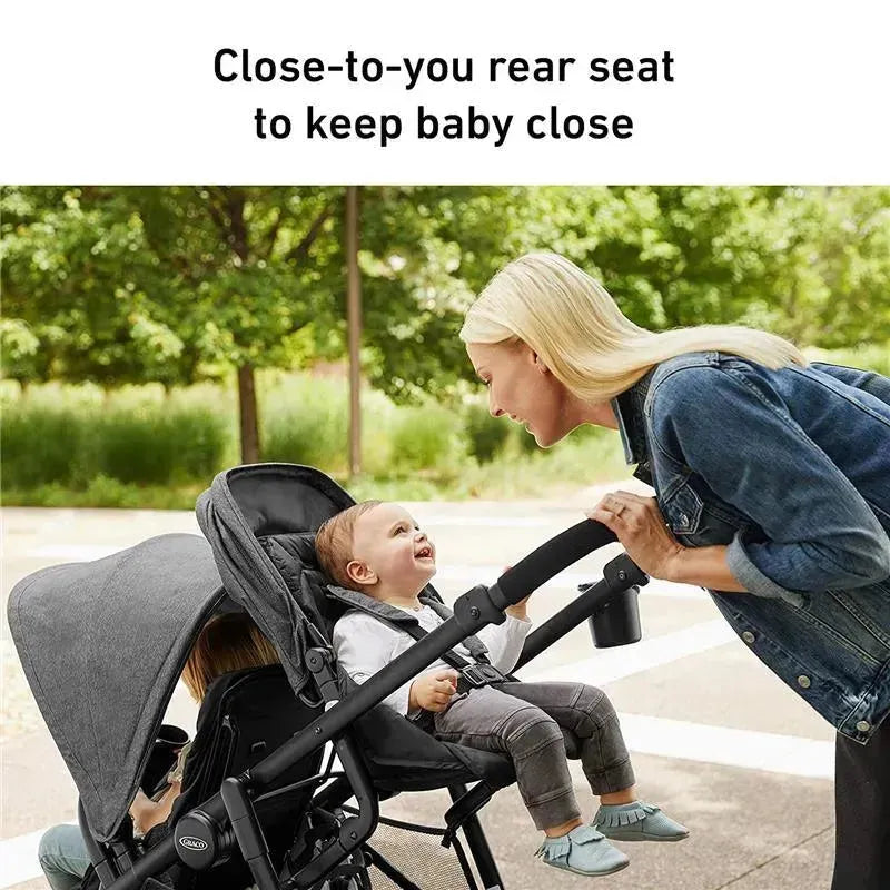 Graco Ready2grow Lx 2.0 Double Stroller in Clark with a mother interacting with her smiling baby in a park setting.