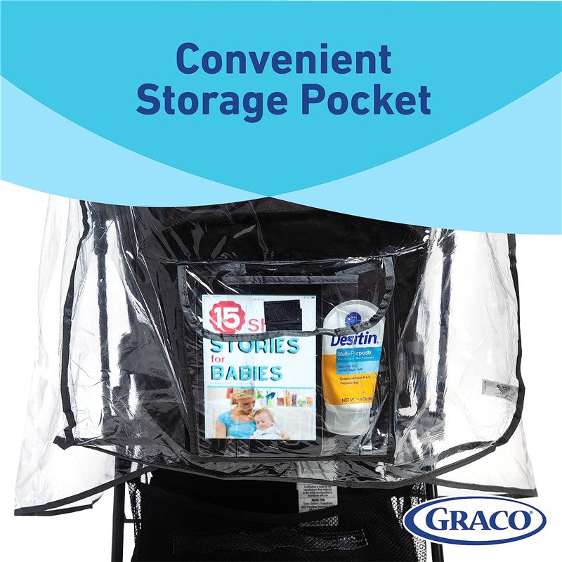 Weather shield for Graco travel system featuring a transparent storage pocket, displaying a baby storybook and diaper cream.