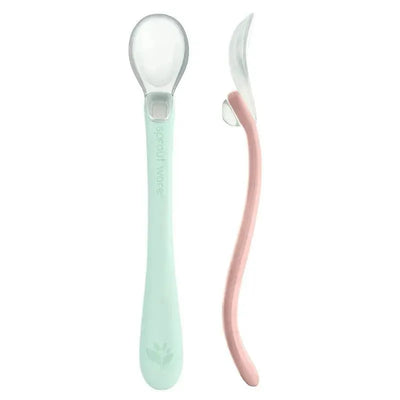 Silicone baby spoons in light sage and light grapefruit, featuring a clear scoop and ergonomic design for easy feeding.
