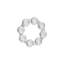 Clear, circular teether with multiple textured knobs designed for soothing infants during teething.