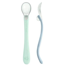 Two silicone baby spoons in light sage and light blueberry colors, designed for first foods.