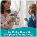 A woman joyfully plays with a Flappy Elephant plush toy with a toddler in a cozy, bright room.
