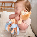 Toddler joyfully hugs a Gund Bingo Lovey Plush, featuring a tan and cream animal head with an orange blanket.