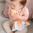 Infant cuddling a Gund Bingo Lovey Plush, a soft toy with a patterned blanket, creating a comforting bond.