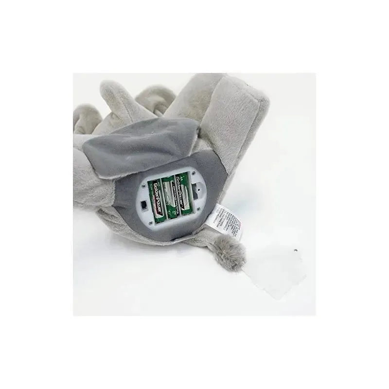 Battery compartment of a gray plush elephant toy, displaying three batteries and a switch.