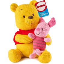 Knit plush toys of Winnie the Pooh and Piglet, featuring bright colors and a tag indicating Gund and Disney branding.