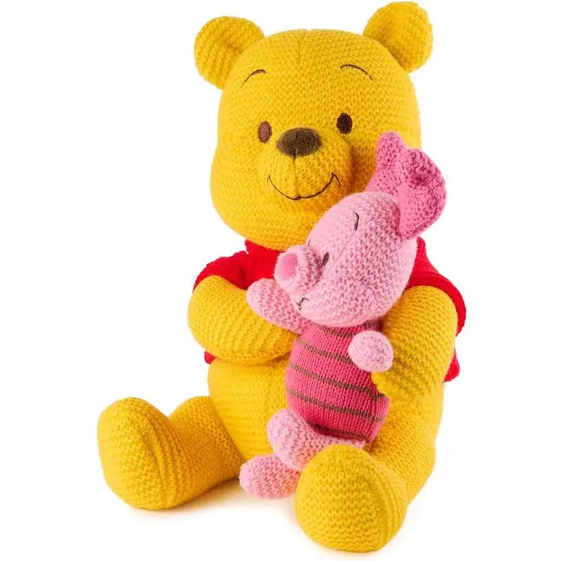 Knit plush Winnie the Pooh holding a pink Piglet toy, both with crocheted textures and bright colors.