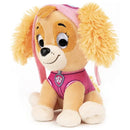 GUND Paw Patrol Skye plush toy with yellow fur, wearing a pink outfit and matching hat, sitting happily.