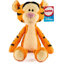 Plush Tigger toy by Gund, featuring orange fur, black stripes, and a hanging tag with brand logo.