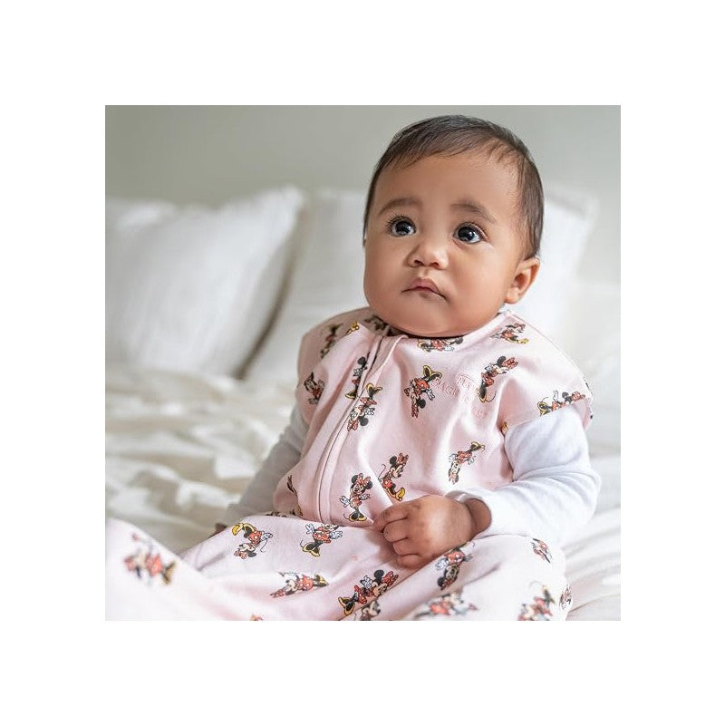 Large HALO SleepSack Wearable Blanket in pink cotton with Minnie Mouse print, worn by a seated baby.