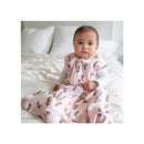 Large HALO SleepSack Wearable Blanket in pink with Minnie Mouse prints, worn by a baby sitting on a bed.