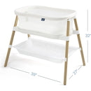 HALO BassiNest Essential Sleeper in white with a mesh sleeping area and wooden frame, featuring a storage shelf below.