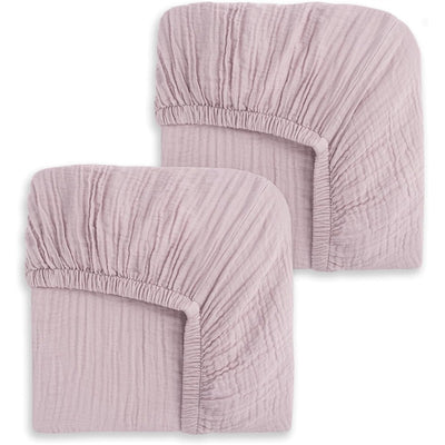 Mauve crib sheets in a 2-pack with soft, textured fabric and fitted elastic edges for secure placement on cribs.