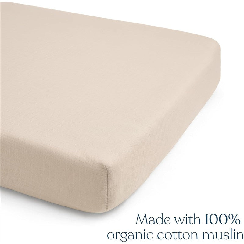 Full-size crib sheet in smooth oat color, made from 100% organic cotton muslin, showing close-up details of the fabric.