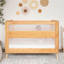 HALO Full-Size Fitted Crib Sheets 2-Pack - White, displayed with a wooden crib featuring mesh sides and a baby swaddled inside.