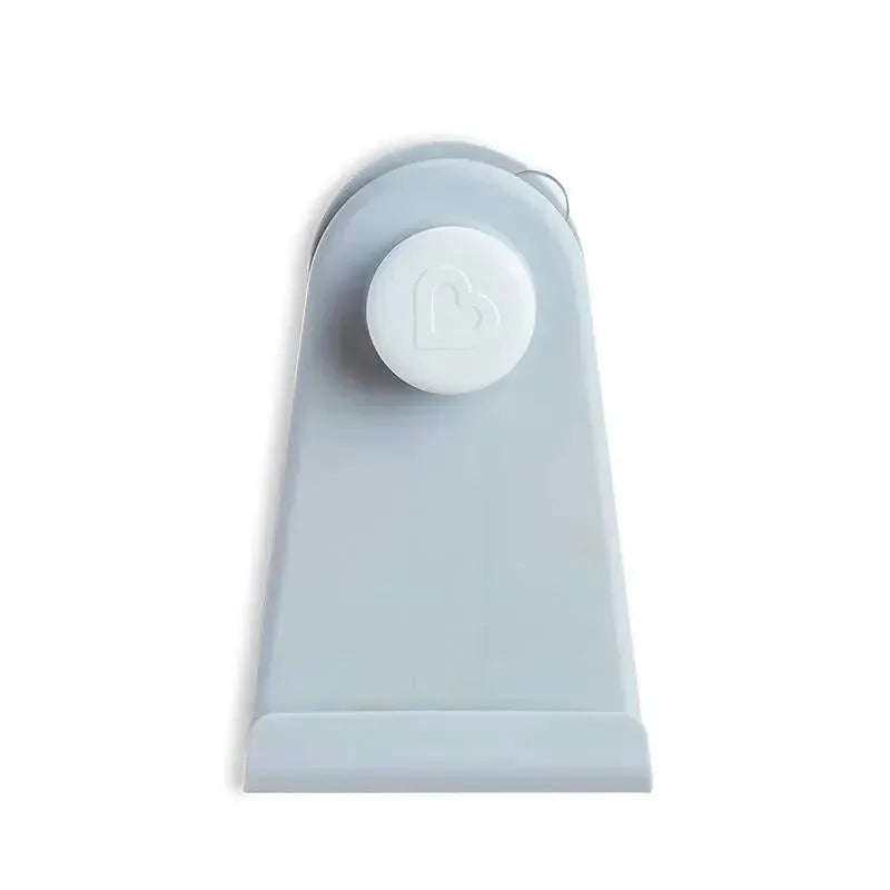Grey hanging bath toy storage by Munchkin featuring a heart-shaped suction mechanism for easy attachment.