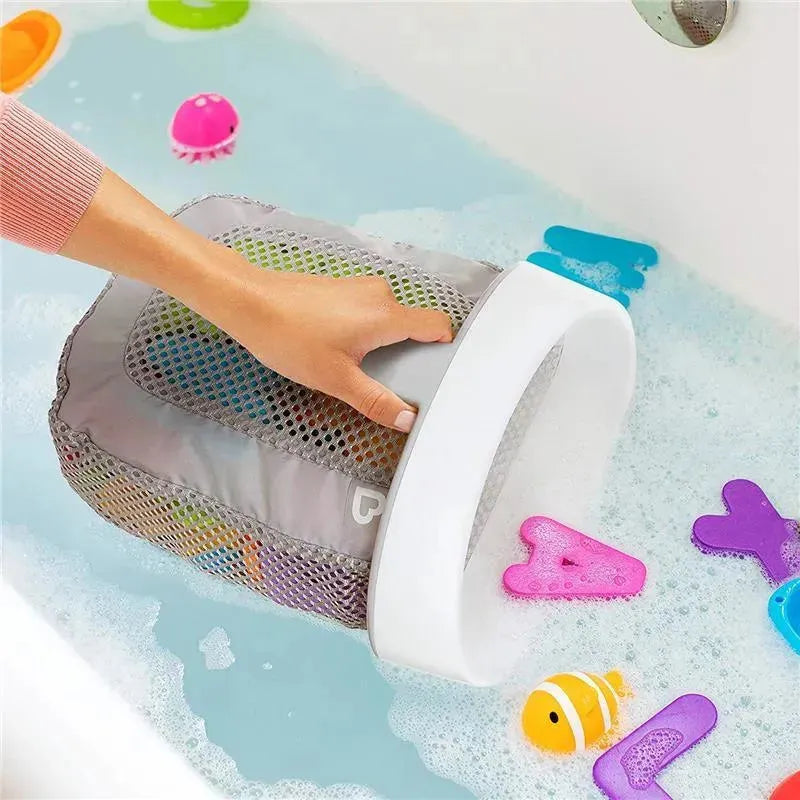 Hanging Bath Toy Storage by Munchkin in grey, being used to store colorful bath toys in a bubbly bathtub.