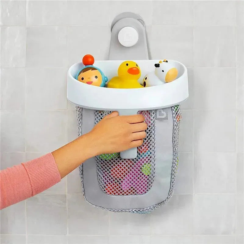 Grey hanging bath toy storage by Munchkin, featuring a mesh net for toys and a hand placing a colorful toy inside.