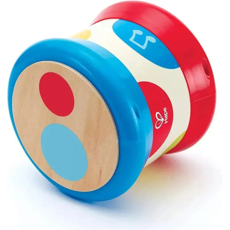 Colorful Hape baby drum featuring a wooden top with red, blue, and yellow dots, designed for musical play.