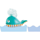 A colorful toy whale with a bubble-blowing feature, floating in water, showcasing a smiling face and striped belly.
