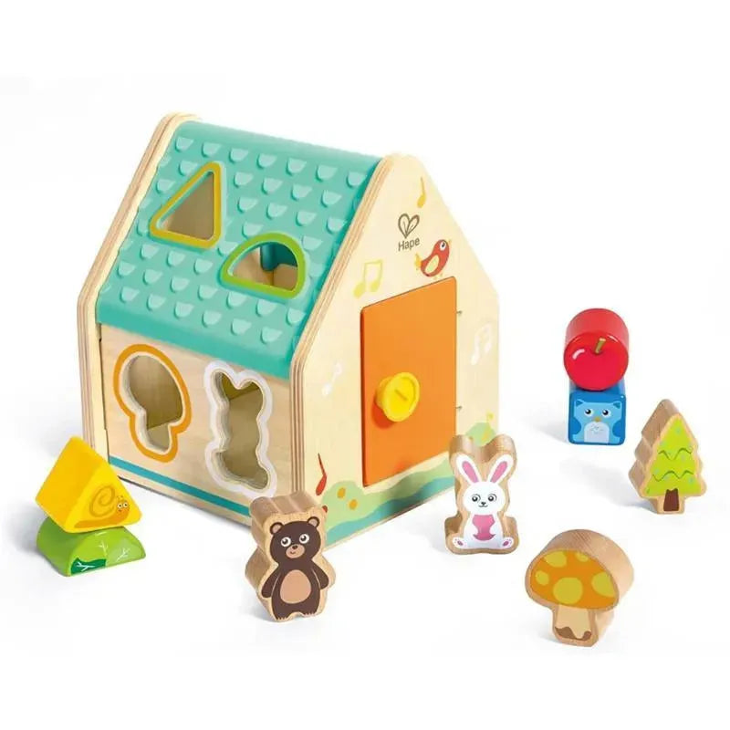 Wooden shape sorter in the form of a house, featuring colorful shape cutouts and six animal and object figures.