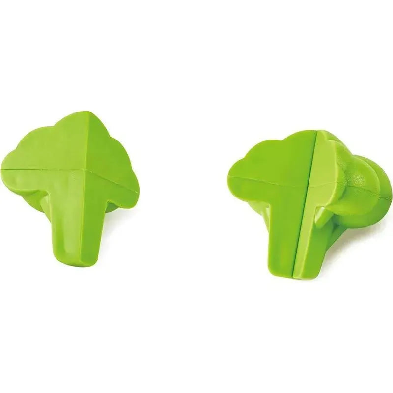 Green plastic broccoli-shaped toy pieces from the Hape Garden Vegetables set for imaginative play.