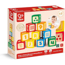 Colorful Hape Grip-N-Stack Silicone & Wood Blocks packaging featuring numbered and patterned blocks, suitable for ages 6-24 months.