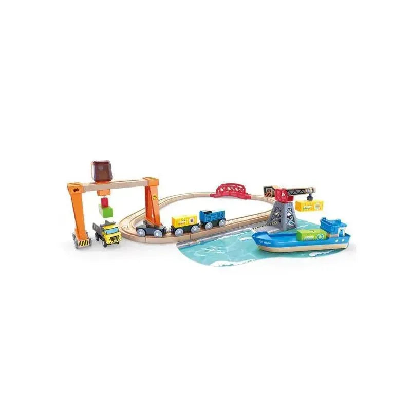 Hape Lift & Load Harbor Set featuring a train track, crane, cargo truck, and a toy boat on a water element.
