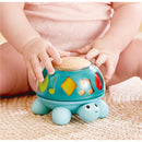 Hape Music Turtle, a colorful musical toy, with a wooden top and playful designs, being used by a baby.