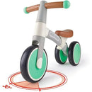 Hape My First Balance Bike in Vespa Green with a sturdy frame, brown seat, and wide tires, suitable for toddlers.