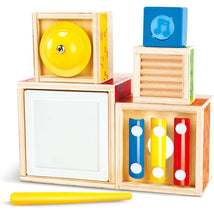 Colorful wooden blocks from the Hape Stacking Music Set, featuring a yellow bell, musical notes, and a yellow stick.