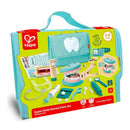 Hape Super Smile Dental Clinic Set with a green and blue carrying case, featuring dental tools and a learning model of teeth.
