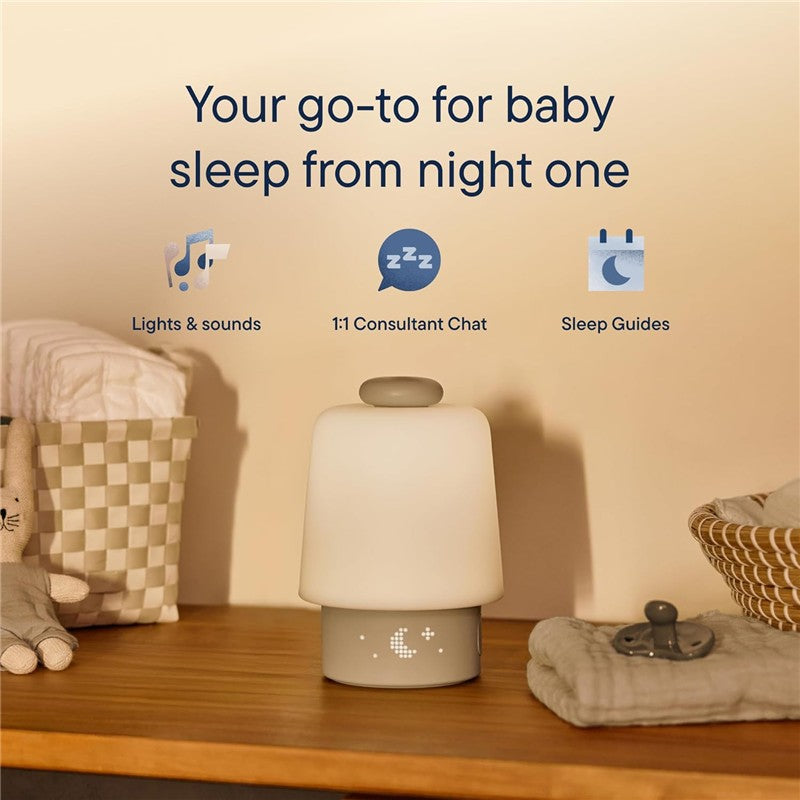 Hatch Baby Sleep Support sound machine and night light in greige, with sleep guidance features and cozy nursery setting.