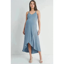 Chambray high-low maternity midi dress with cross back straps, modeled by a woman with a pregnant belly.