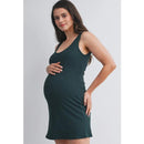 Ribbed maternity active mini dress in hunter green, worn by a woman cradling her pregnant belly.