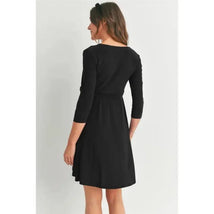 Surplice quarter sleeve nursing dress in black with a waist tie, shown from the back on a model.