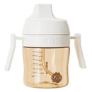 Heorshe dental-care sippy cup, 7Oz/210Ml, with white handles and lid, and a translucent amber body showing measurement markings.