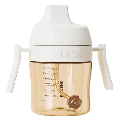Heorshe dental-care sippy cup, 7Oz/210Ml, with white handles and lid, and a translucent amber body showing measurement markings.
