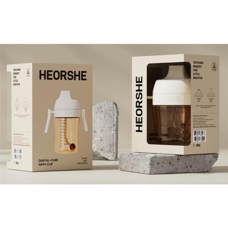 Heorshe Dental-Care Sippy Cup in white, 7oz/210ml, designed for children 6 months and older, shown in packaging with teething remedy text.