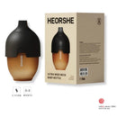 Heorshe ultra wide neck baby bottle, 5oz/160ml in black, displayed next to its packaging with safety details and age recommendations.