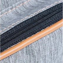 Grey fabric of the Hug - New York Backpack featuring a sturdy zipper with tan piping.