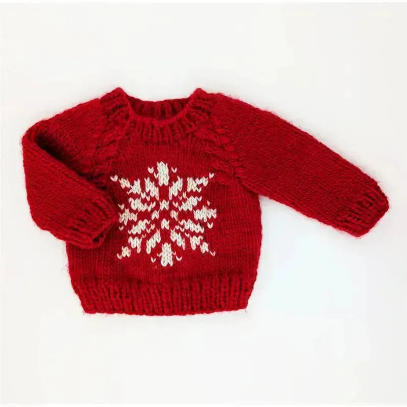 Red crew neck sweater for babies featuring a white snowflake design on the front.